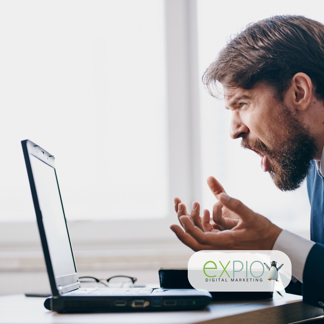 Profile of a businessman frustrated with what he's looking at on his computer screen.